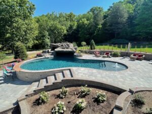 Backyard oasis with pool and waterfall feature.