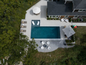 Aerial view of residential backyard pool and patio area.